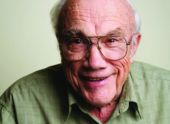 An older gentleman in glasses, smiling